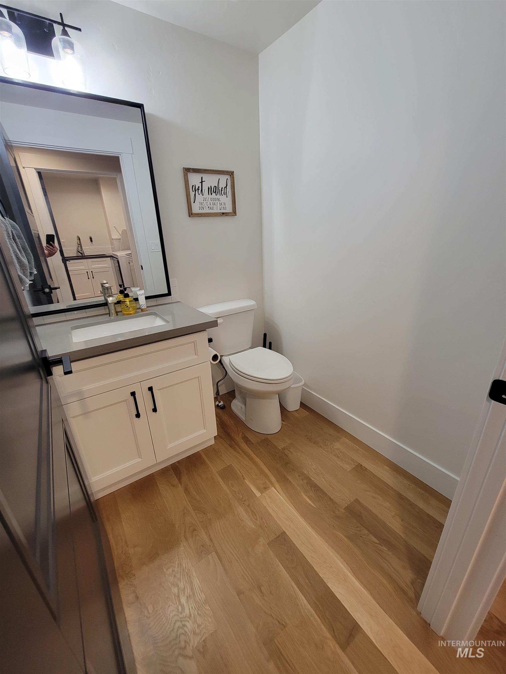 Bathroom featuring wood finished floors and vanity