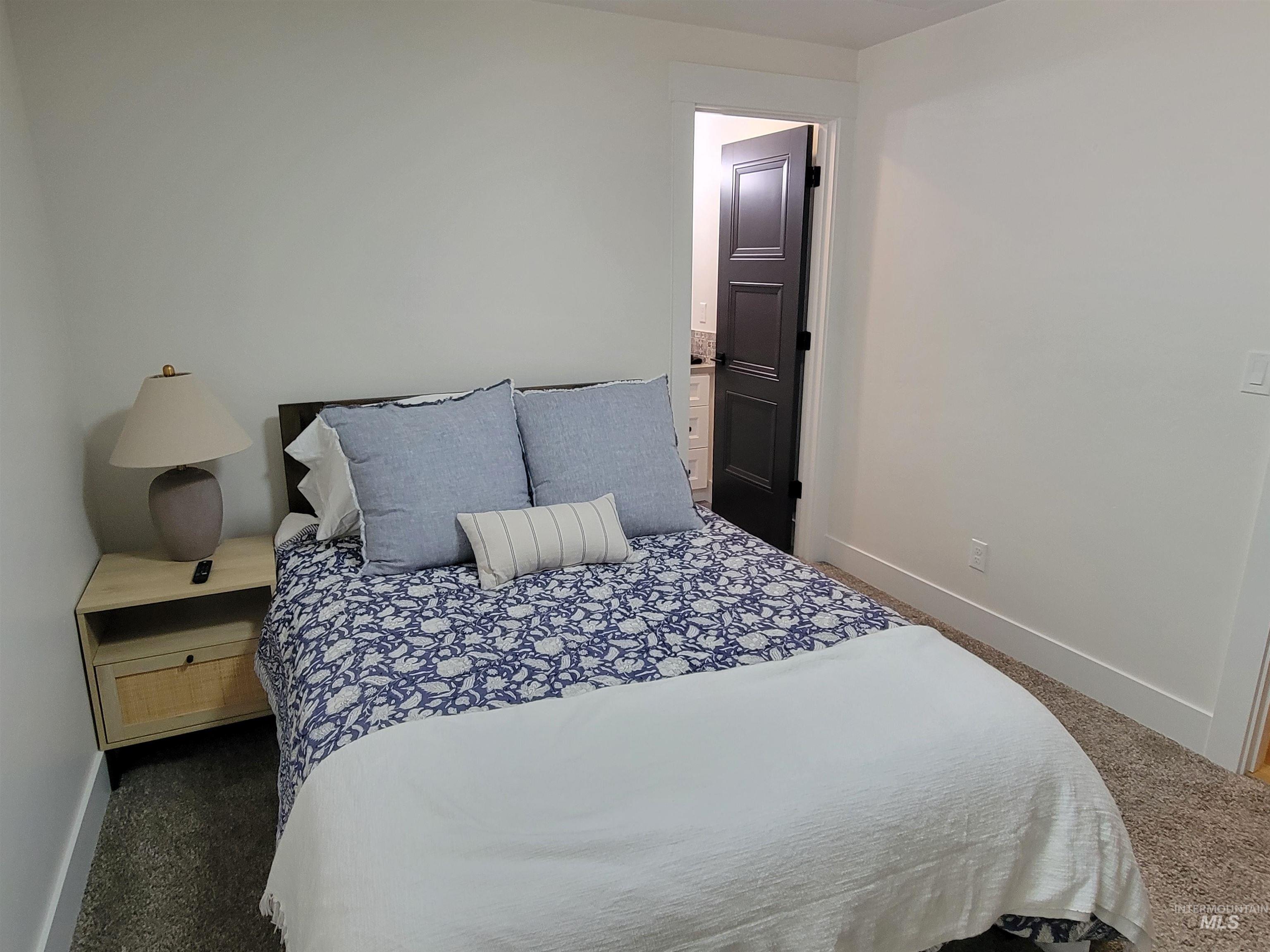 Bedroom featuring dark carpet