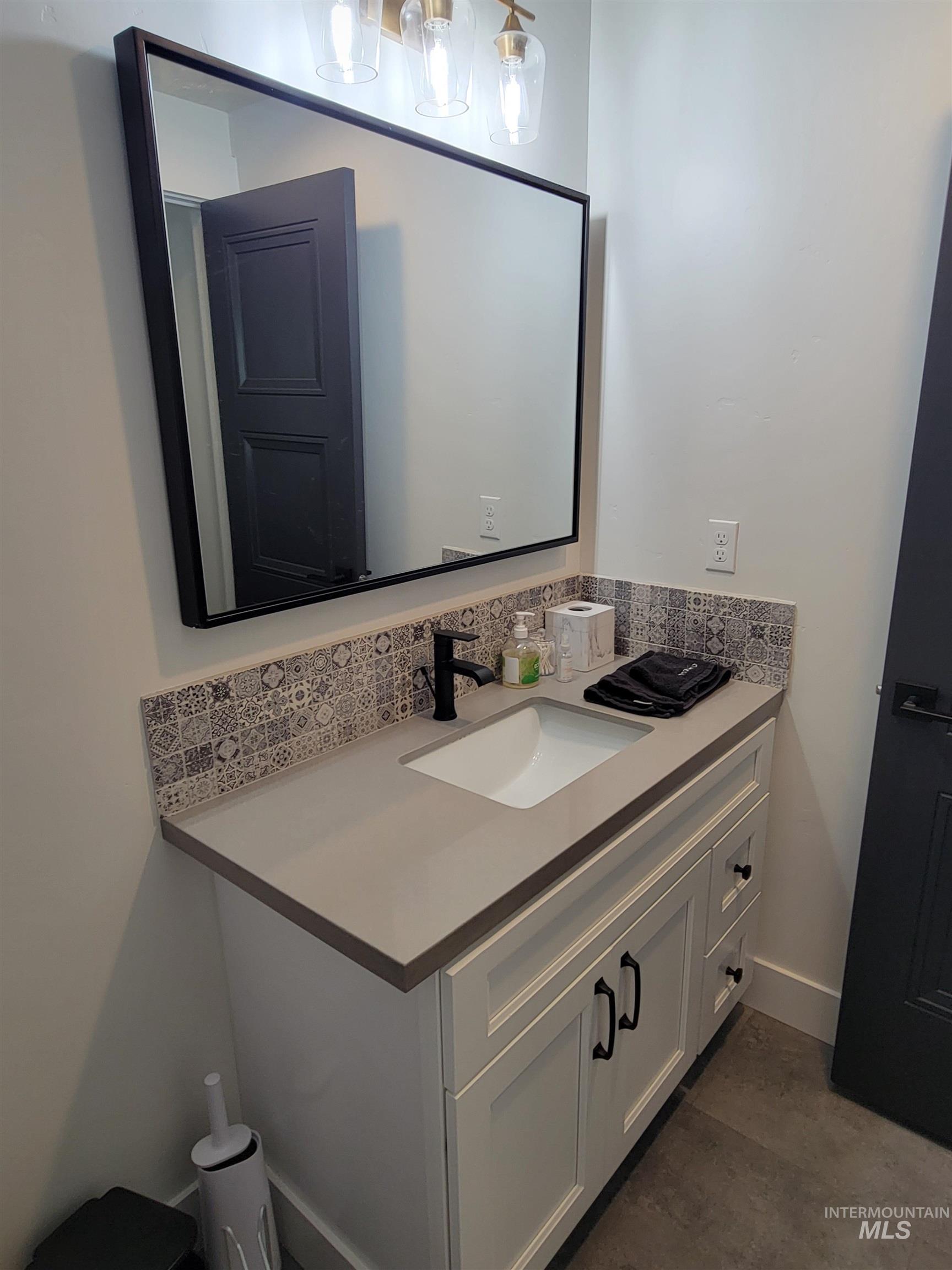 Bathroom featuring vanity and baseboards