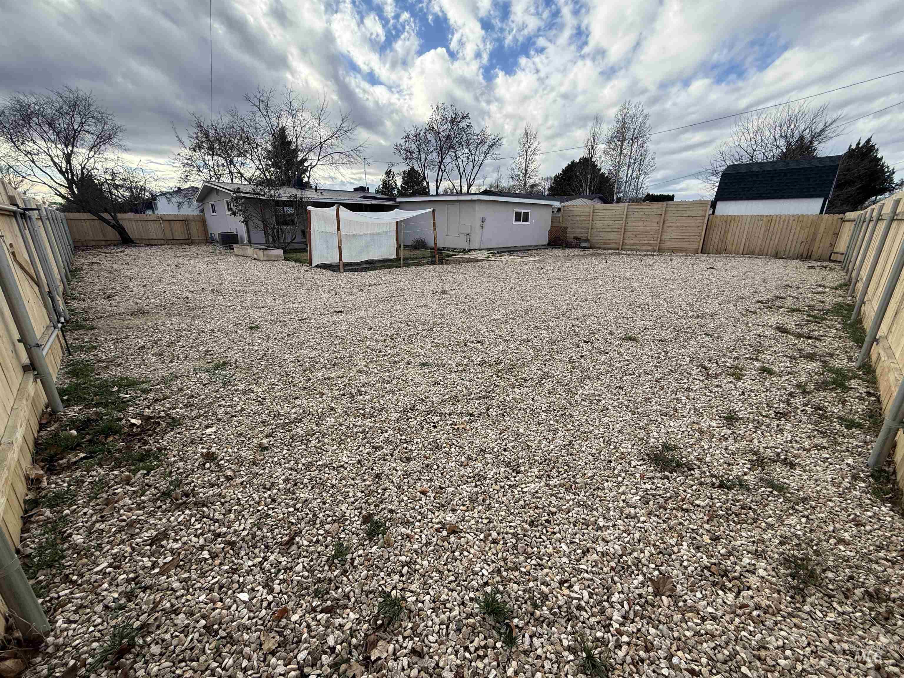 Rear view of house featuring a fenced backyard