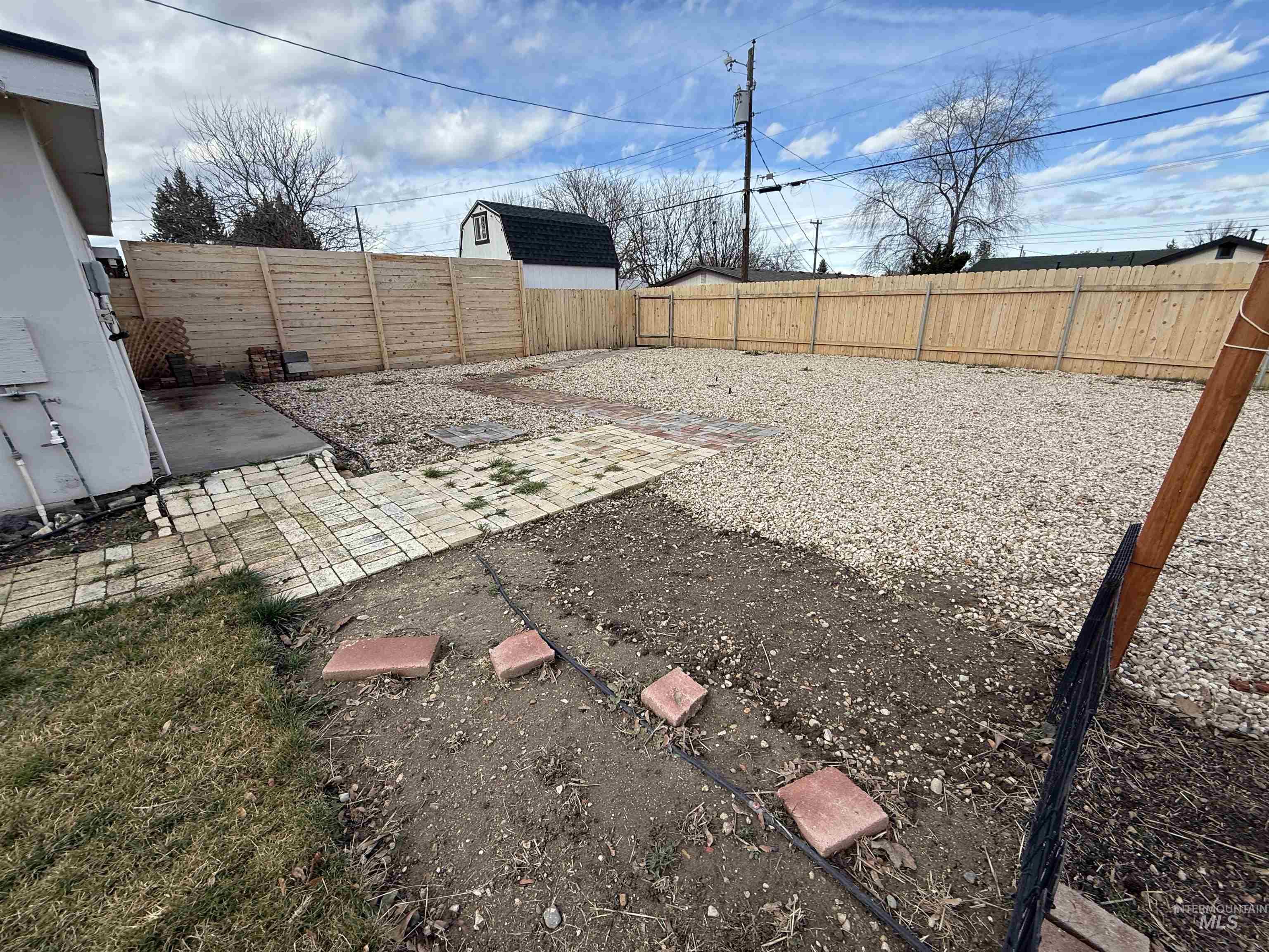 Fenced backyard with a patio