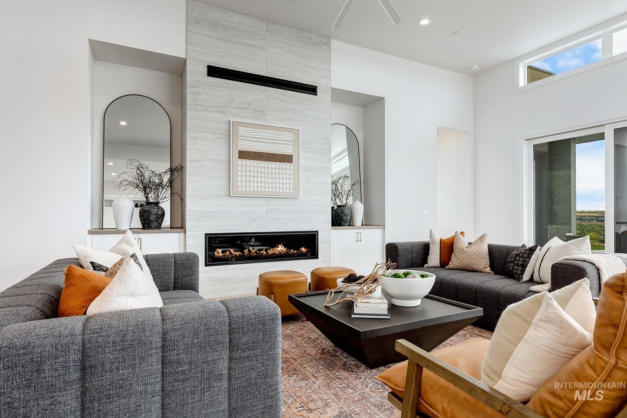 Living area featuring a tiled fireplace, healthy amount of natural light, recessed lighting, and ceiling fan