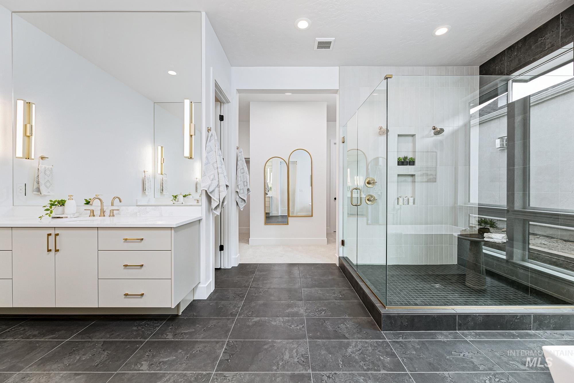 Full bathroom featuring a stall shower, vanity, and recessed lighting