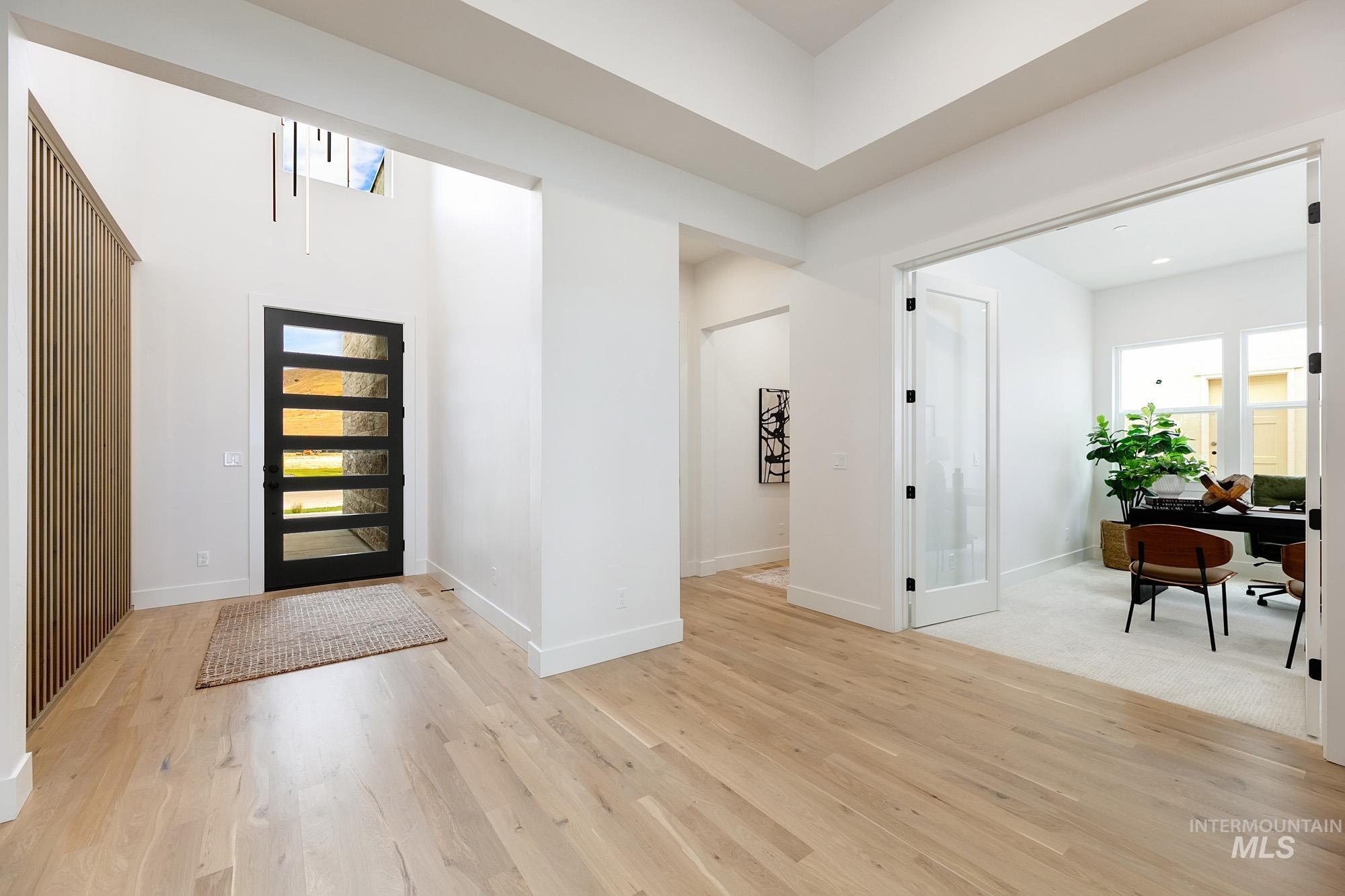 Foyer entrance featuring light wood-type flooring and plenty of natural light