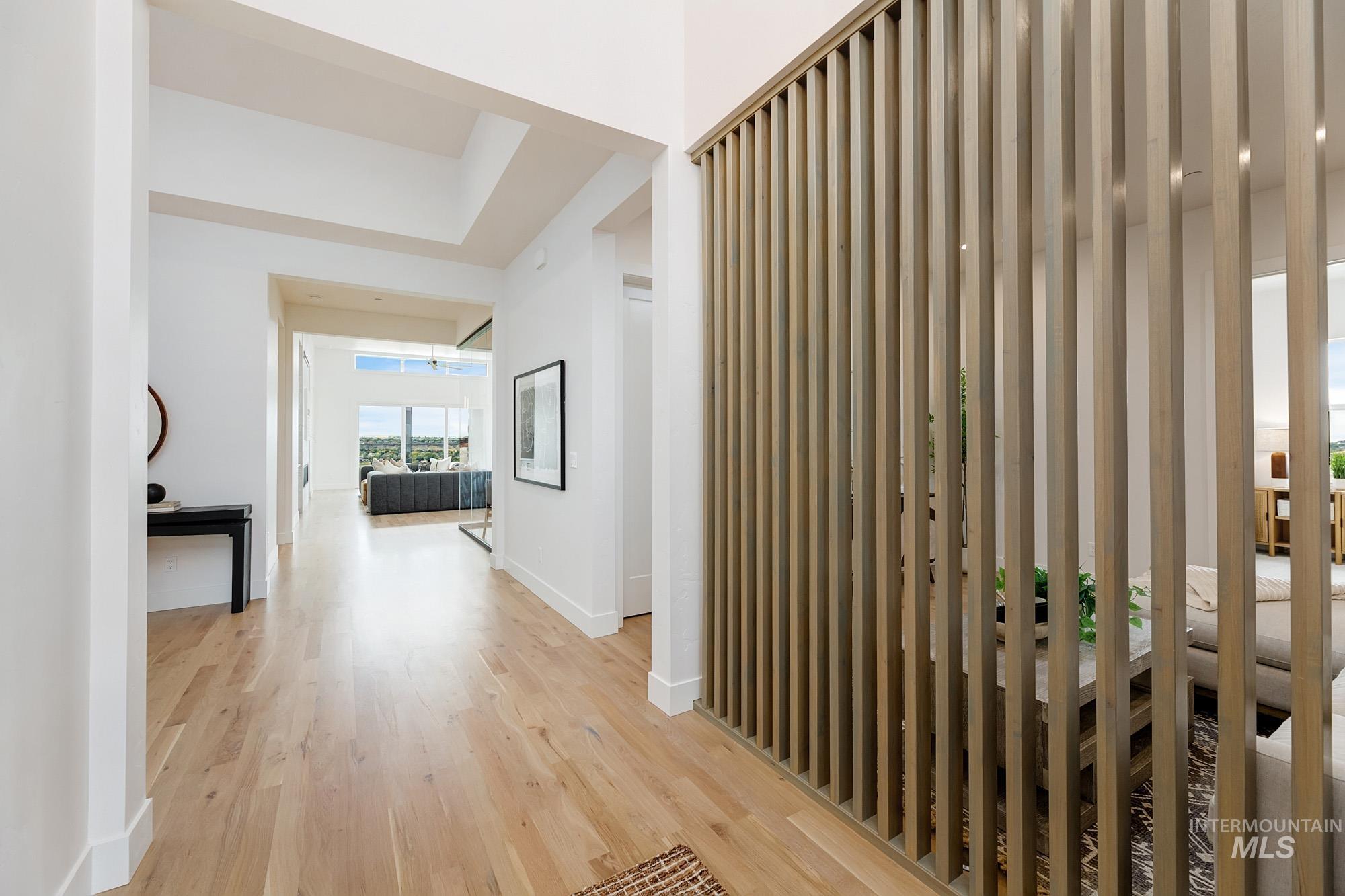 Corridor with light wood-style floors and baseboards