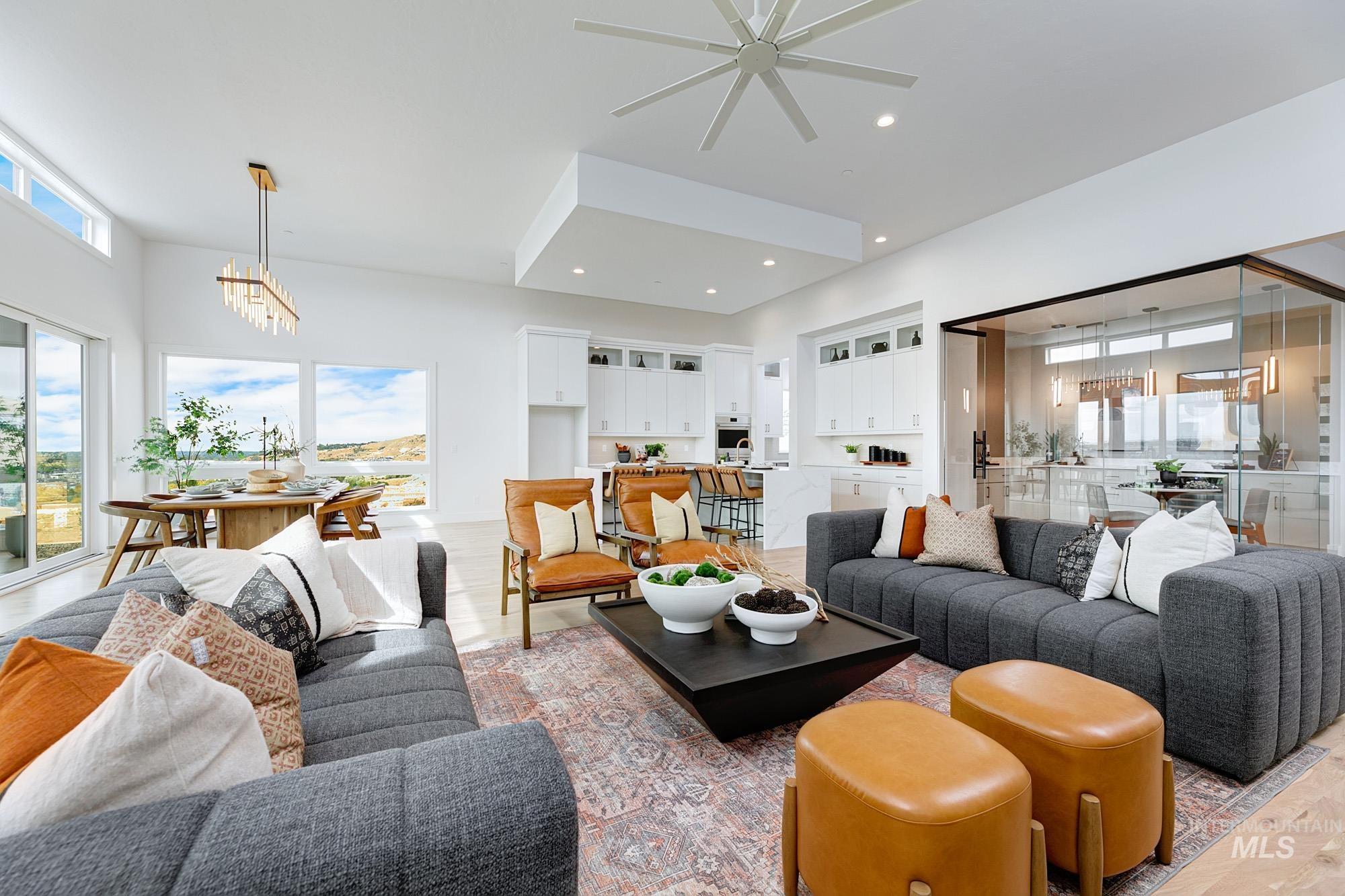 Living area featuring plenty of natural light, a chandelier, light wood-style flooring, and recessed lighting