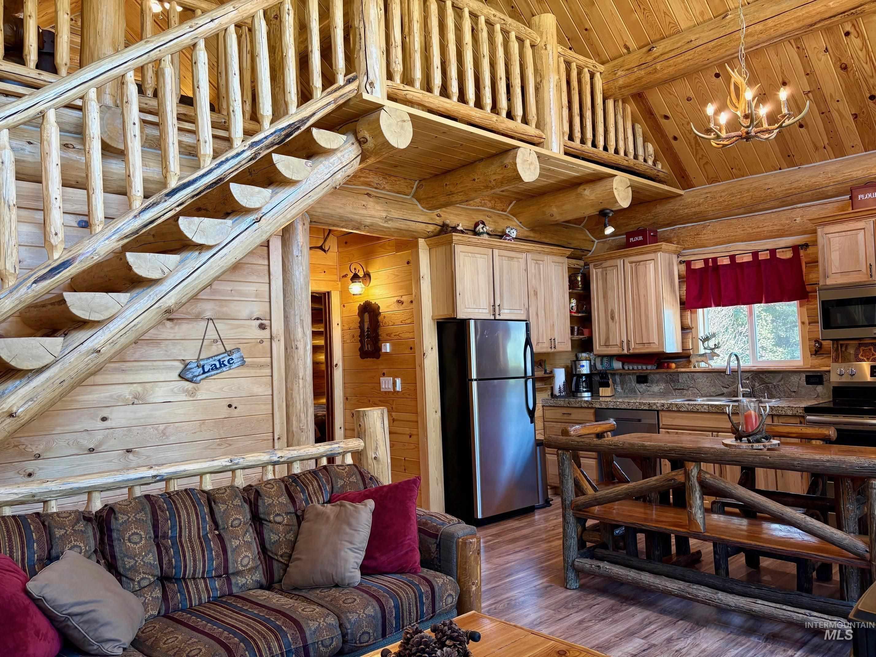 Kitchen with wood ceiling, stainless steel appliances, dark wood finished floors, open shelves, and a chandelier