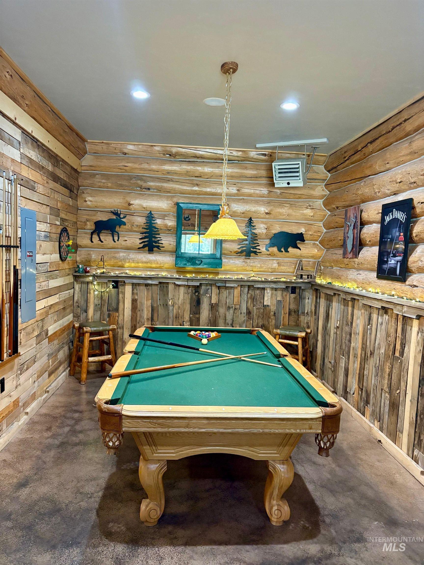 Playroom featuring billiards table, recessed lighting, a heating unit, concrete flooring, and log walls