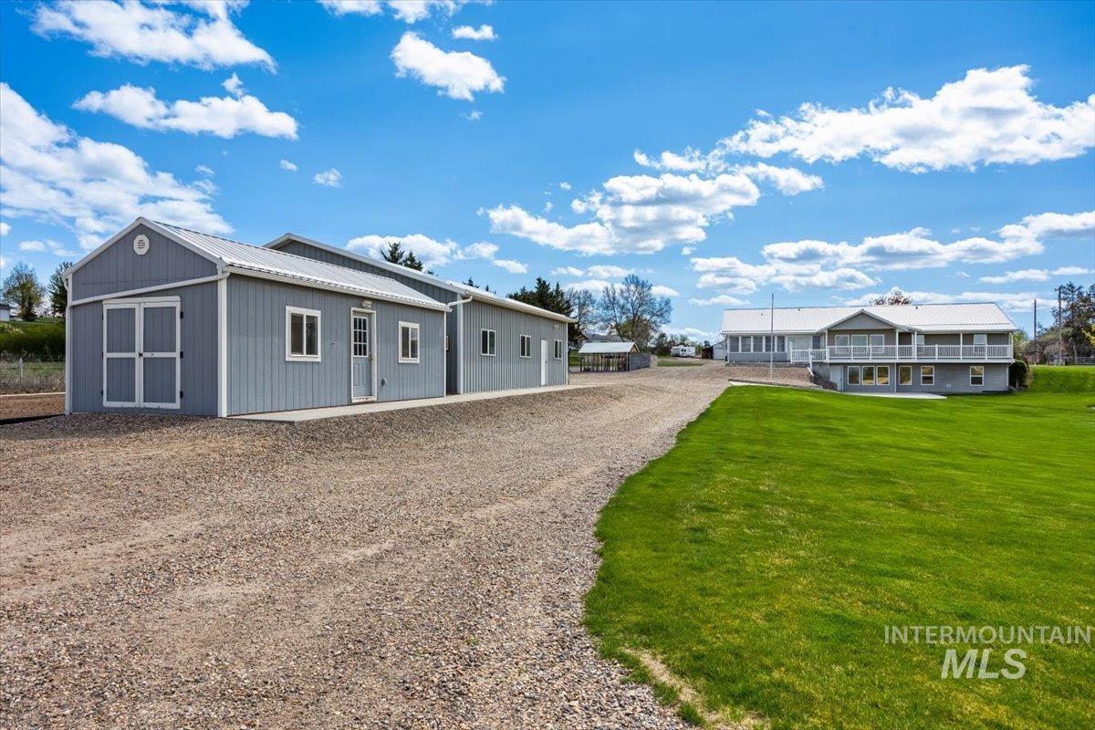 View of front of home featuring a front yard and a metal roof