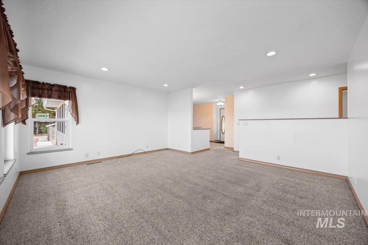 Spare room with light carpet and recessed lighting