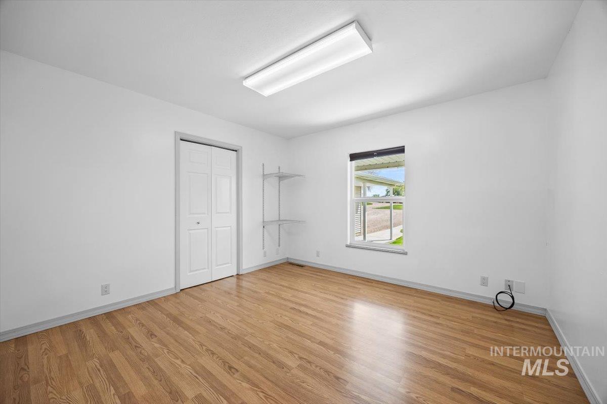Unfurnished bedroom featuring a closet and light wood-type flooring