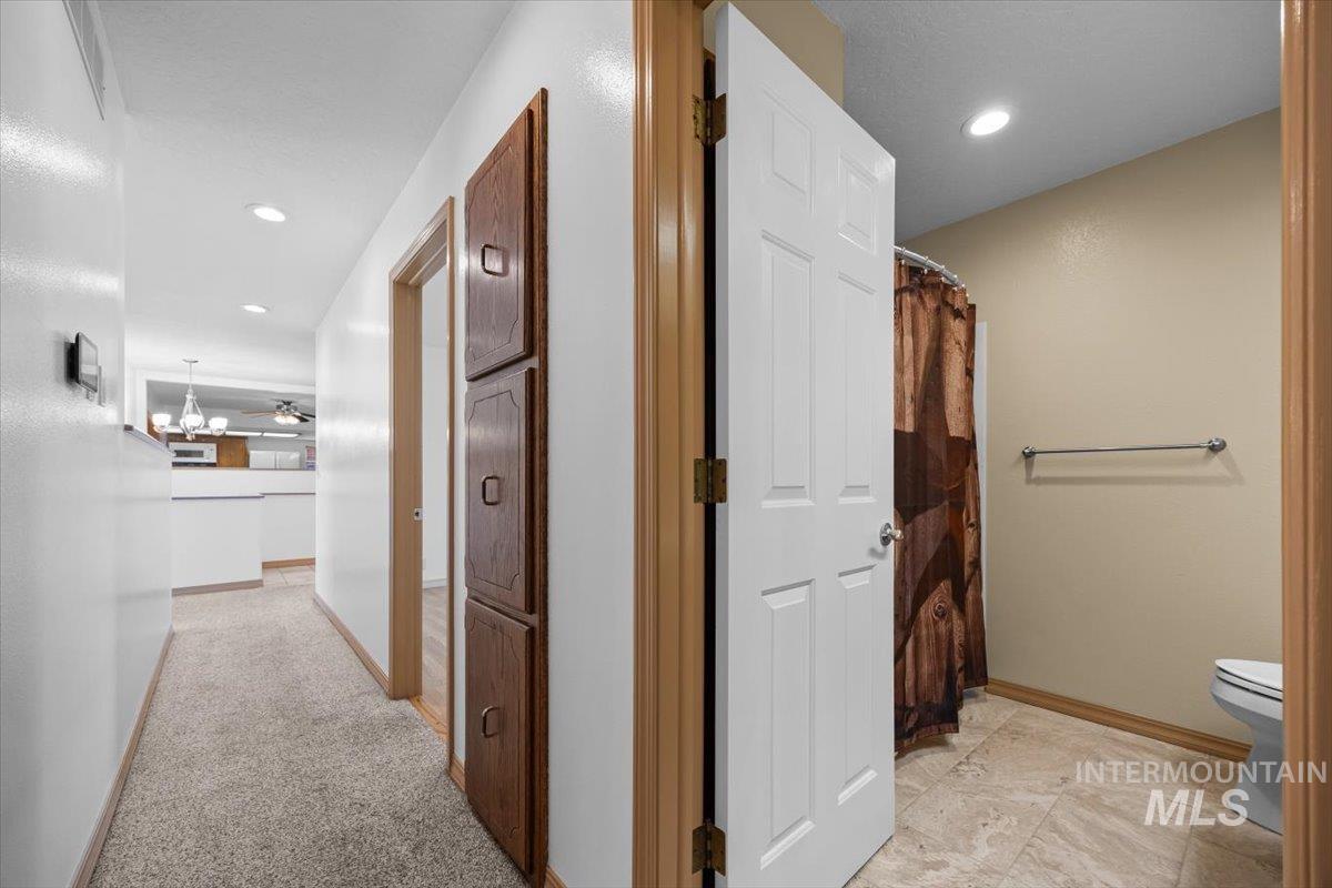 Hall featuring recessed lighting and light colored carpet