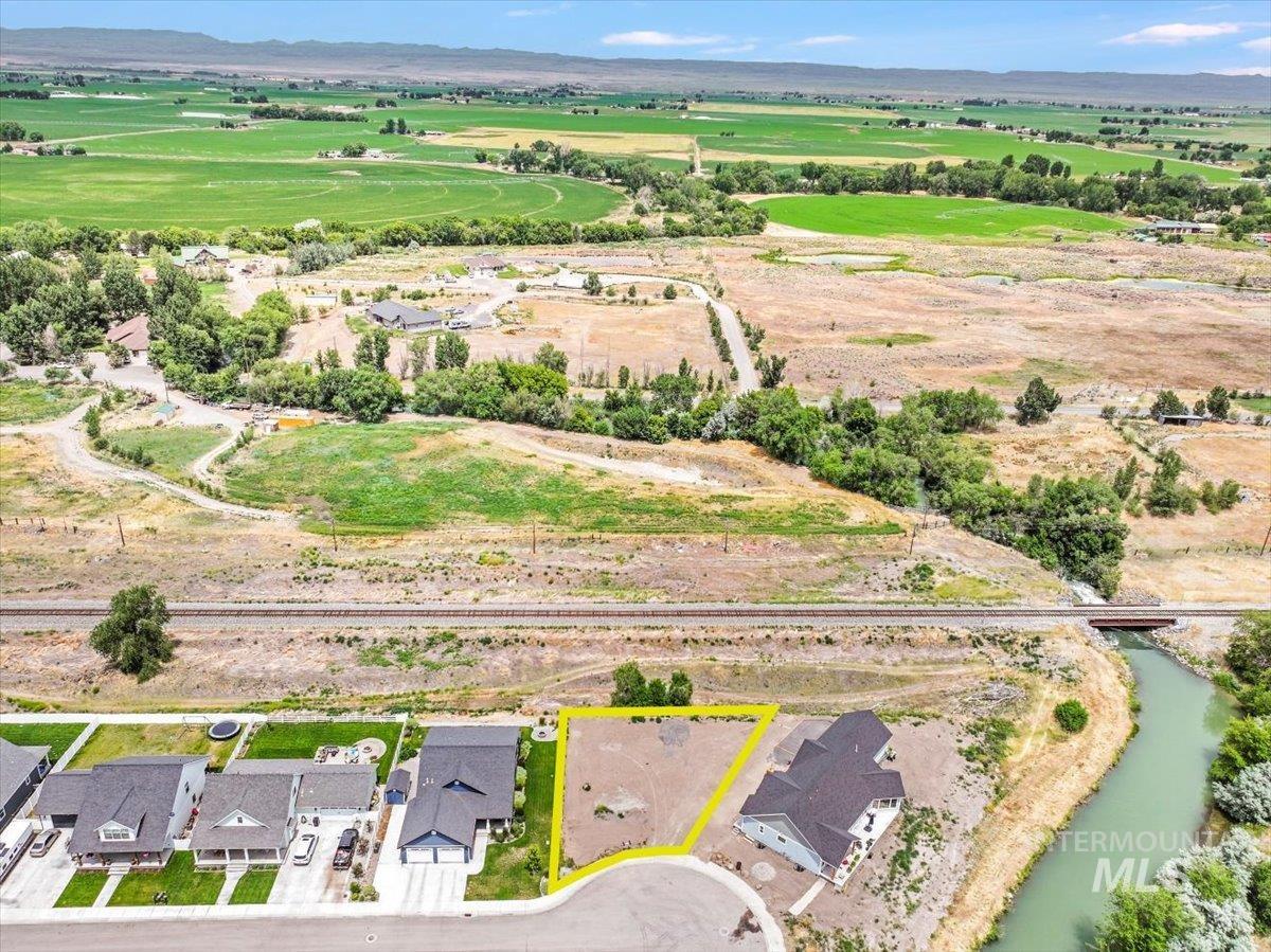 Aerial overview of property's location with property parcel outlined and a water and mountain view