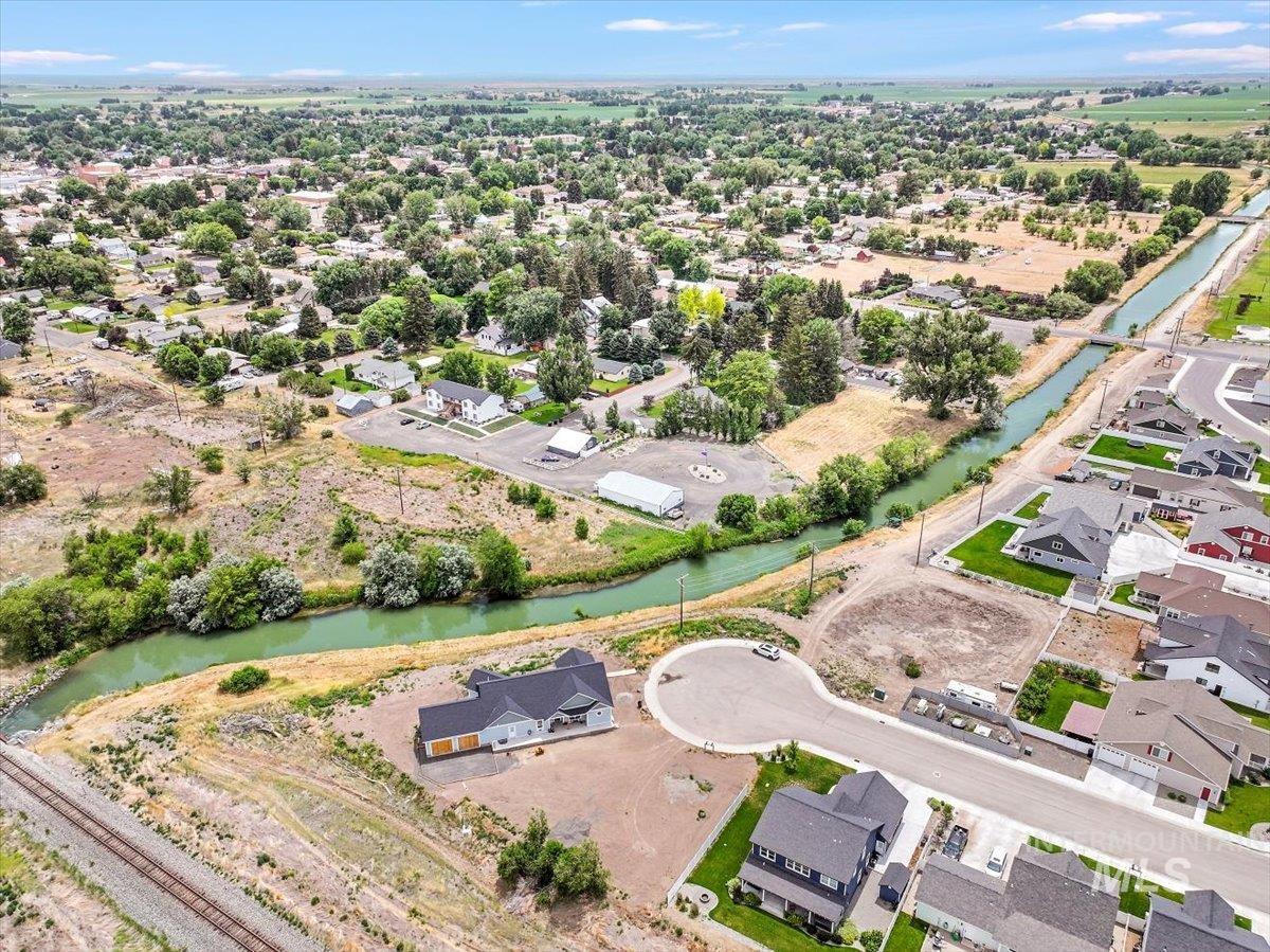 Aerial overview of property's location featuring a large body of water and nearby suburban area
