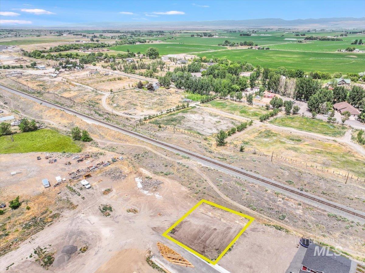Aerial view of sparsely populated area with property parcel outlined