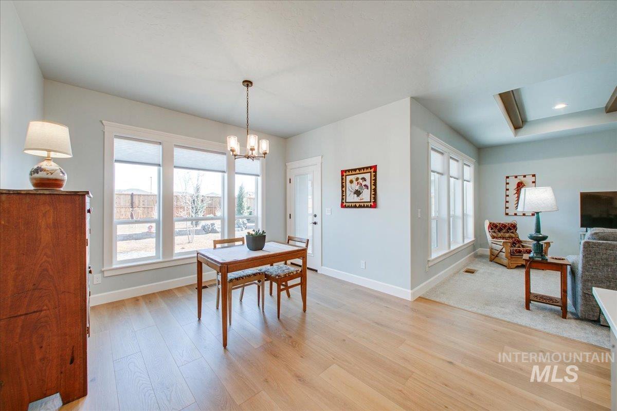 Dining space with light wood-style flooring and a chandelier