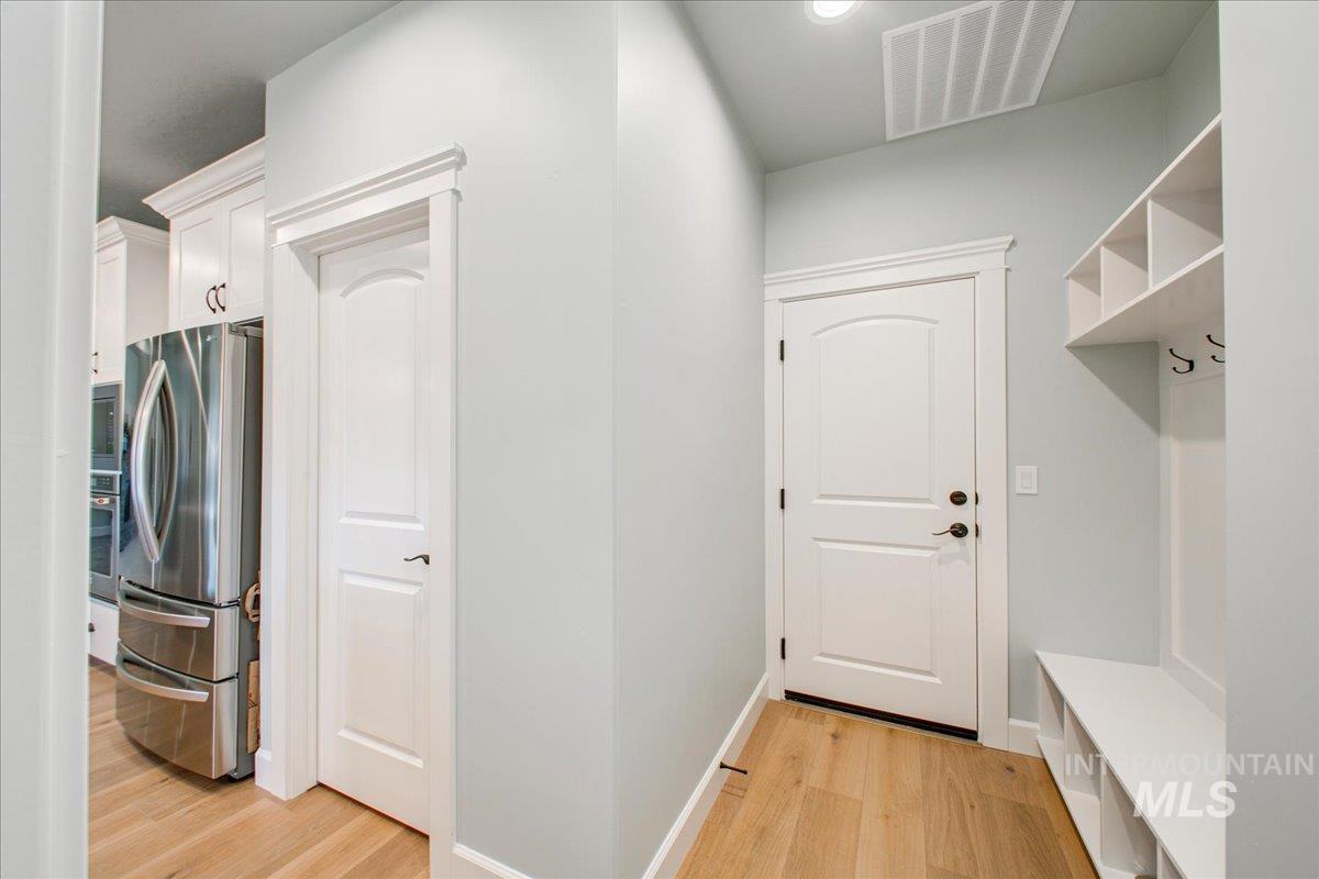 Mudroom with light wood finished floors