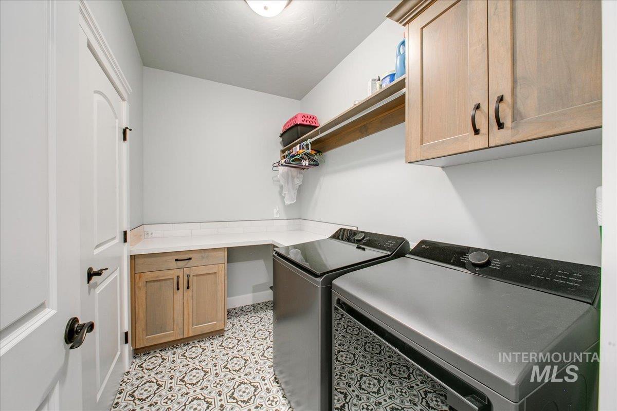 Laundry room with cabinet space and washer and clothes dryer