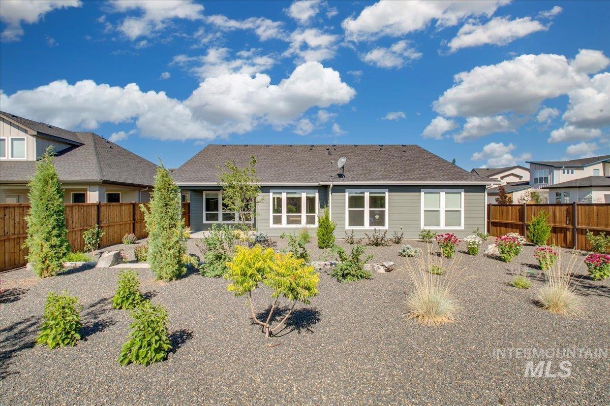 Rear view of property with a fenced backyard
