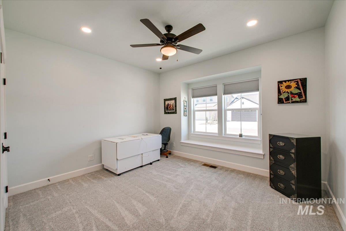 Bedroom featuring a ceiling fan, light colored carpet, and recessed lighting