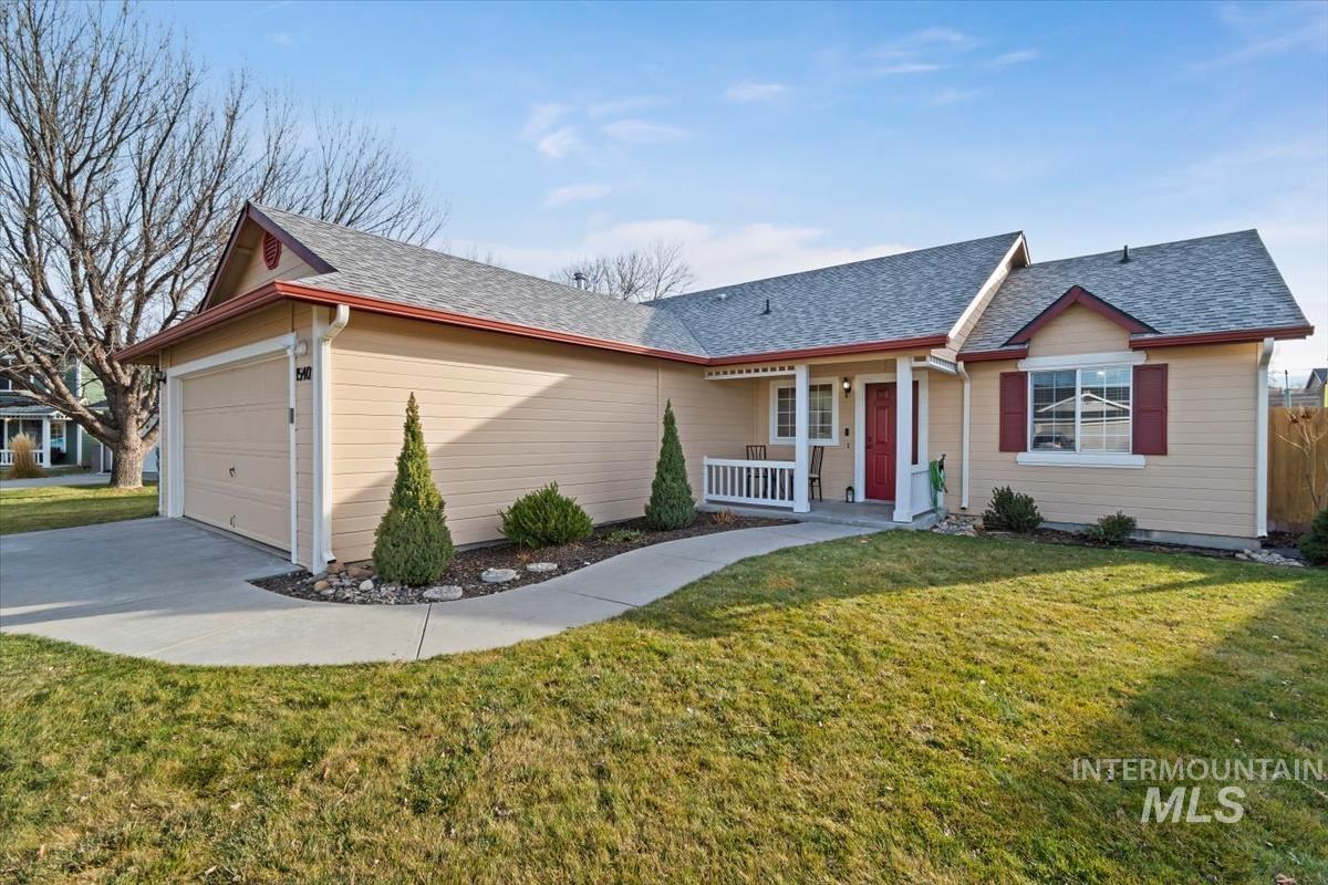 Ranch-style home with covered front porch, deep front yard and two car garage