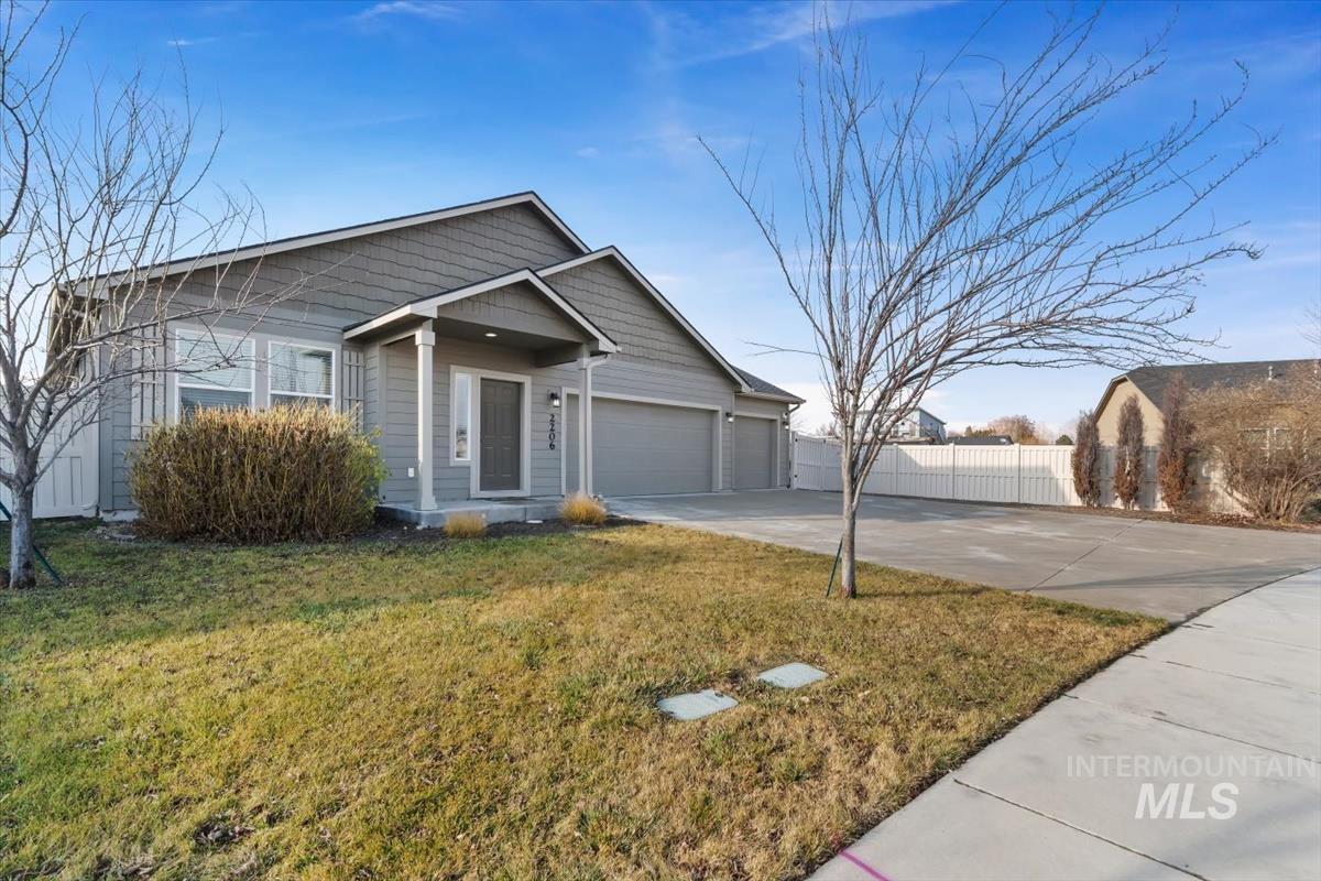 View of front of house featuring concrete driveway and an attached garage