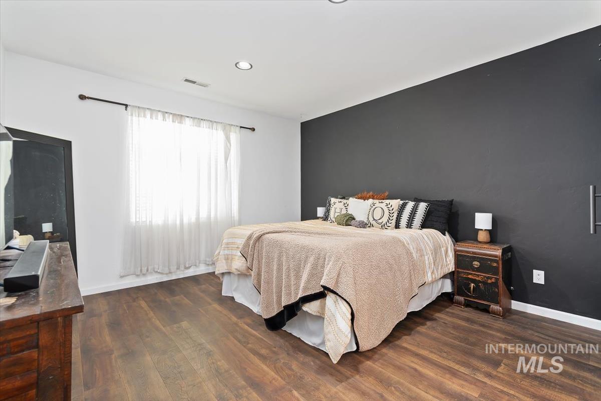 Bedroom featuring dark wood-type flooring