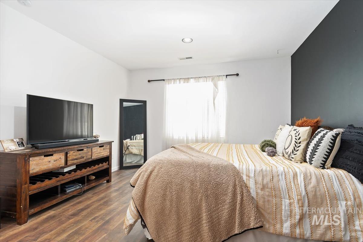 Bedroom with dark wood-type flooring