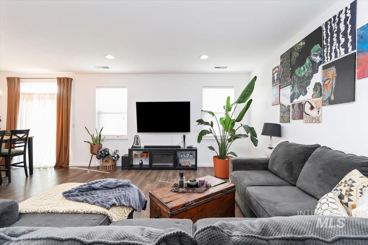 Living room with wood finished floors and recessed lighting
