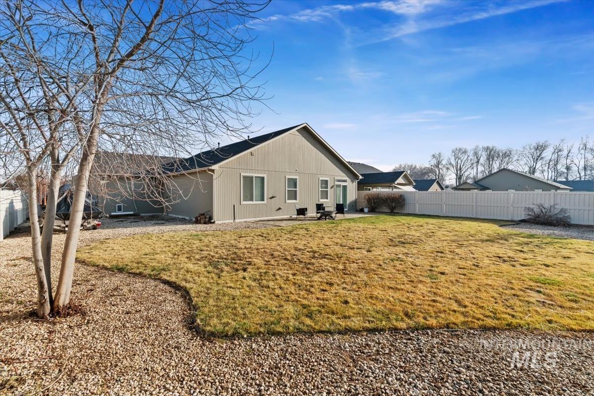 Back of property featuring a fenced backyard