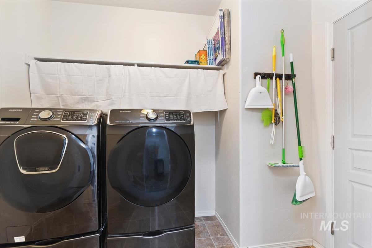 Laundry area featuring baseboards and washer and dryer
