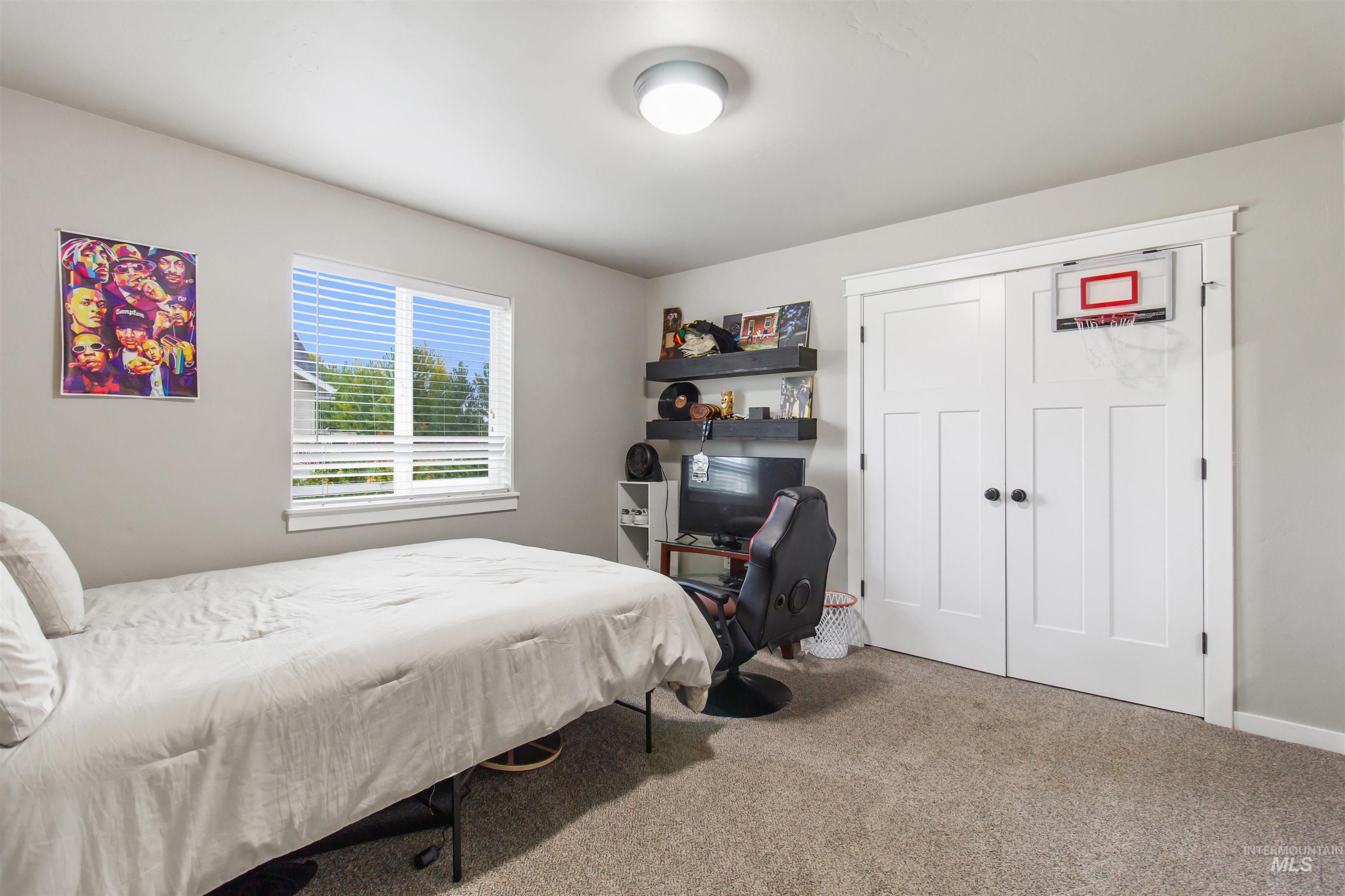 Carpeted bedroom featuring a closet