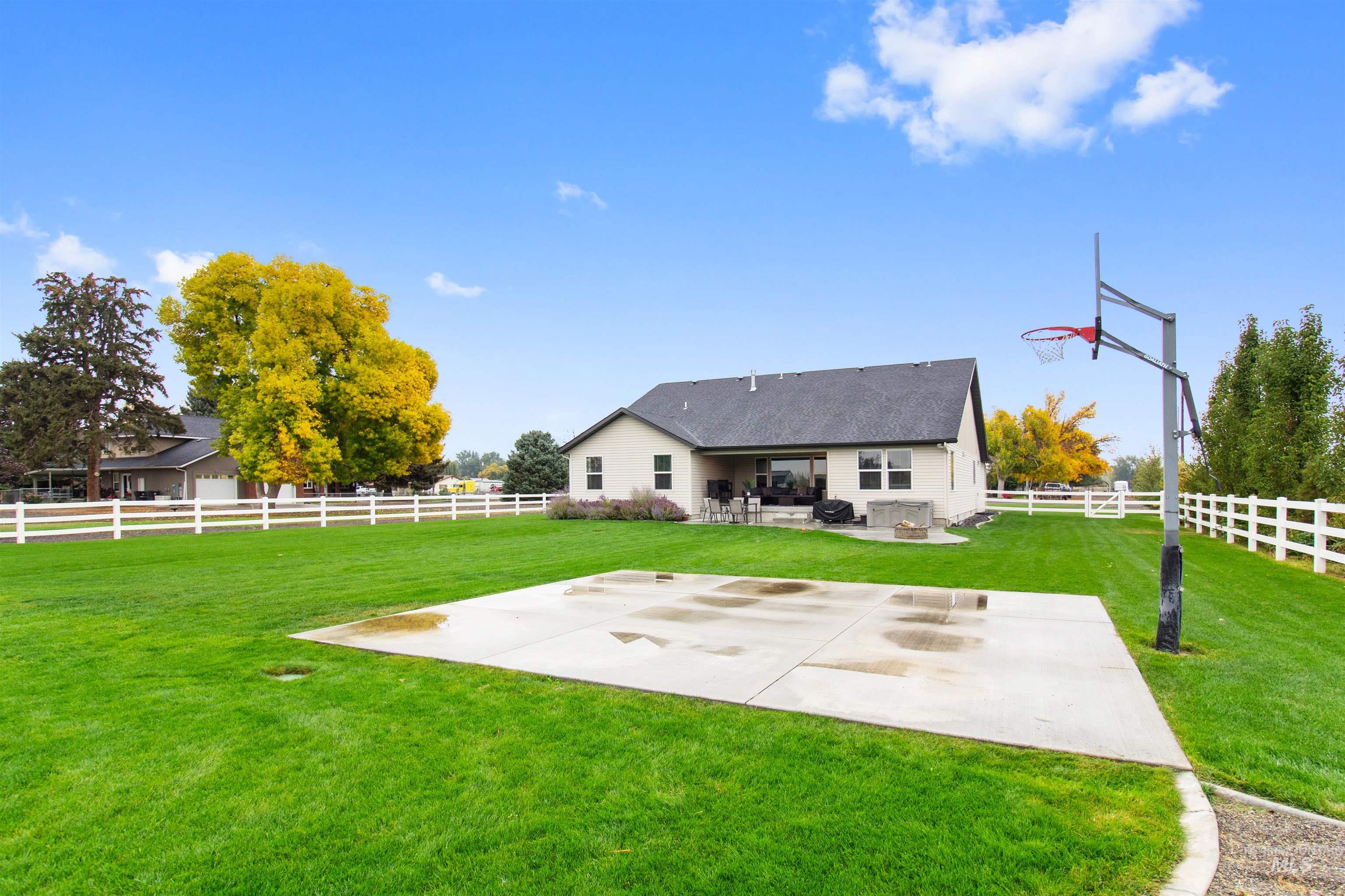 Rear view of house featuring a patio and a fenced backyard