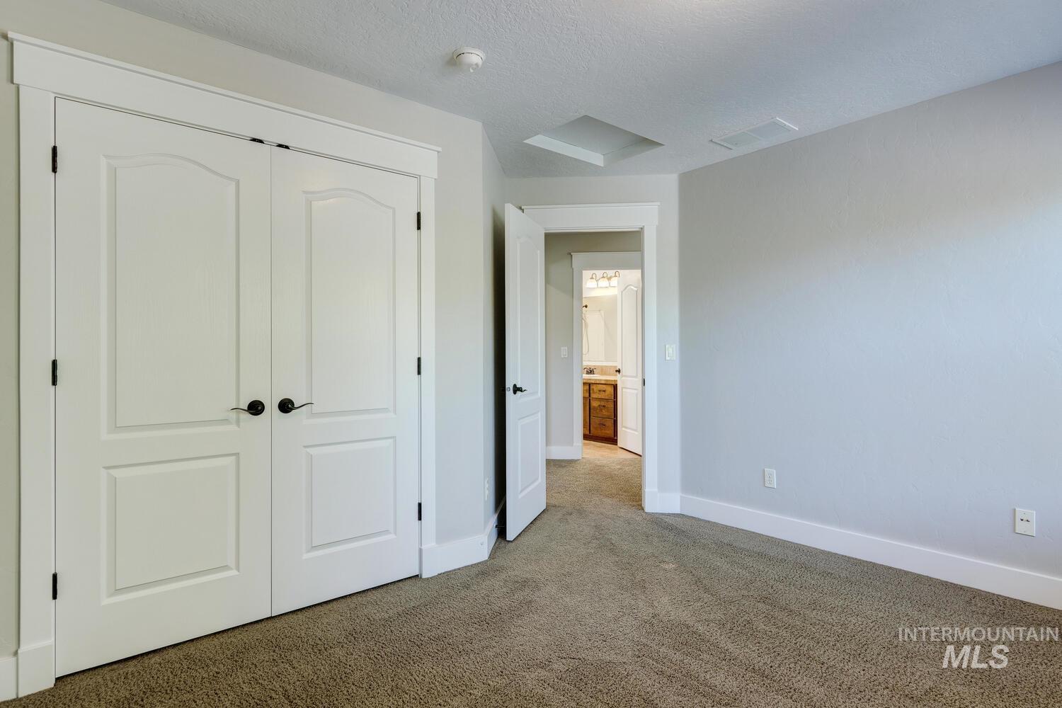 Unfurnished bedroom featuring a closet, carpet flooring, and a textured ceiling