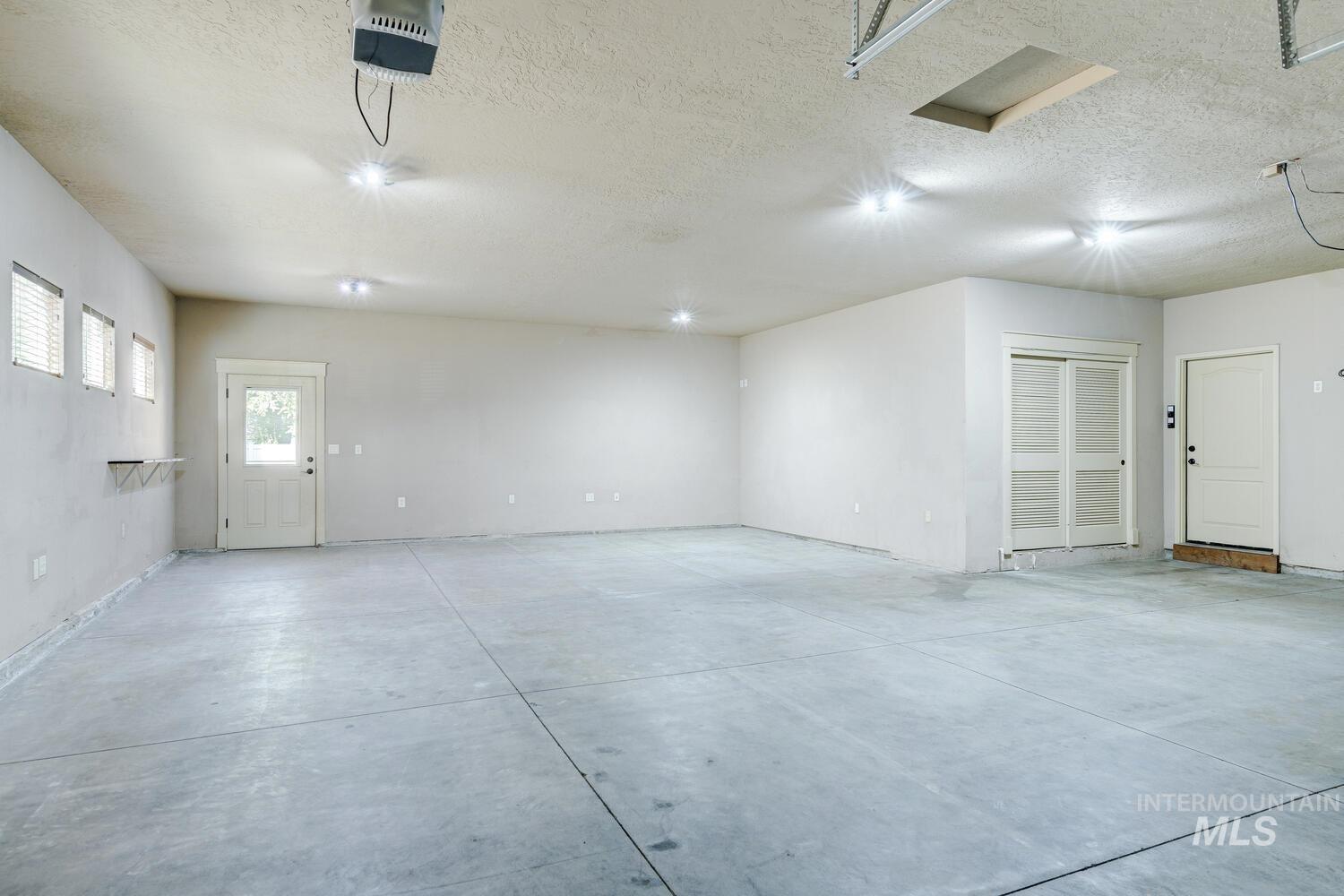 Garage featuring a garage door opener