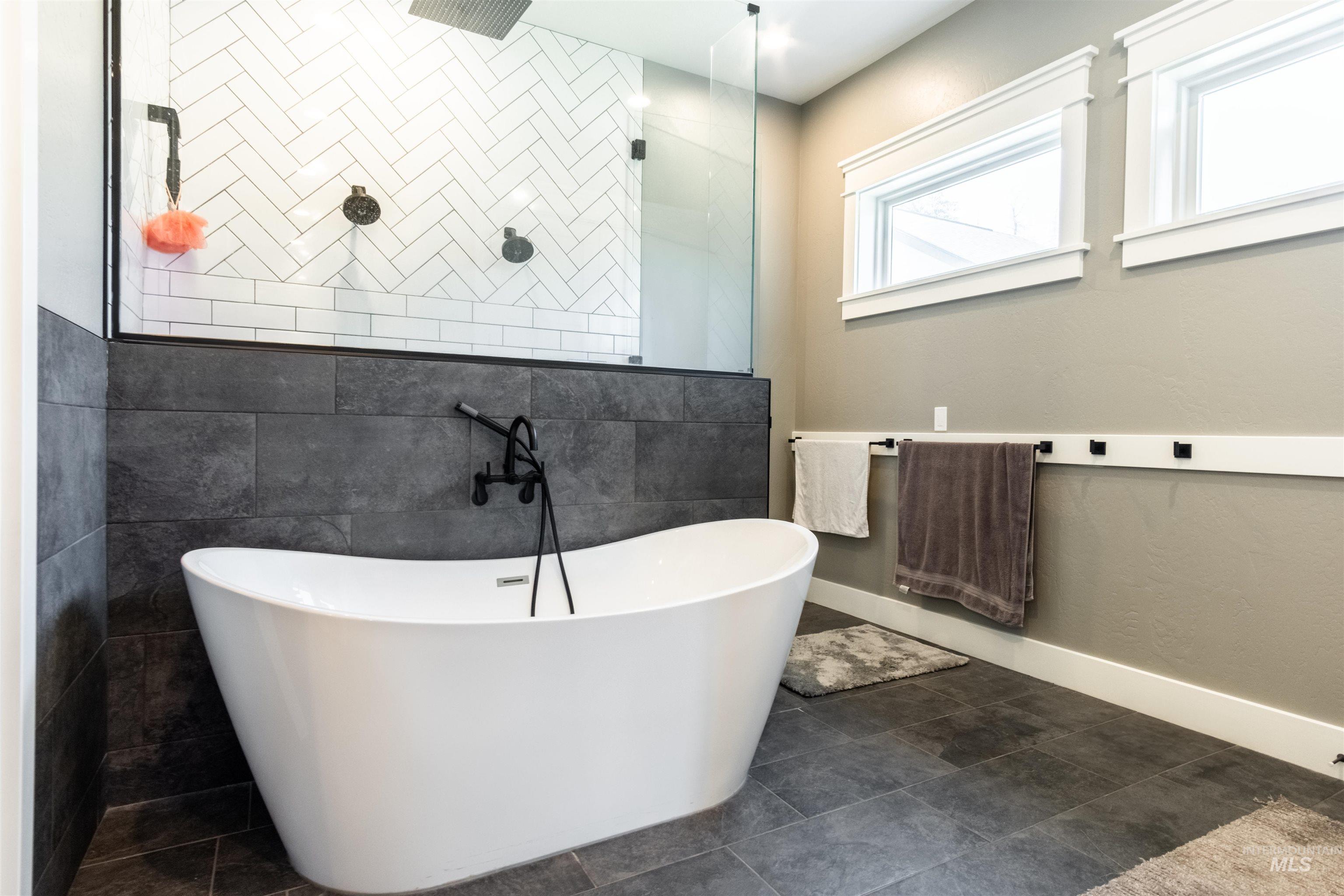 Bathroom with a freestanding tub and a tile shower
