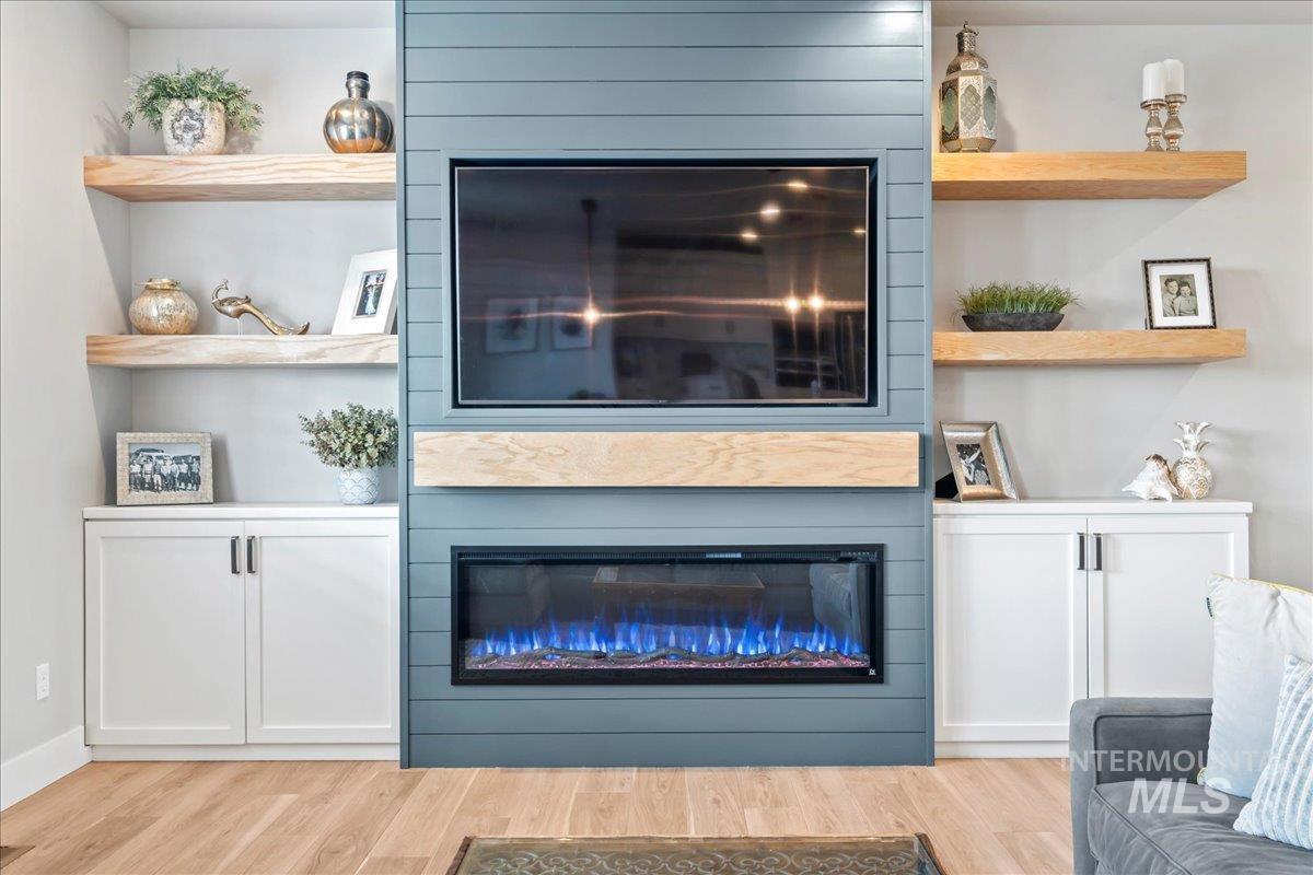 Detailed view of a large fireplace and wood finished floors