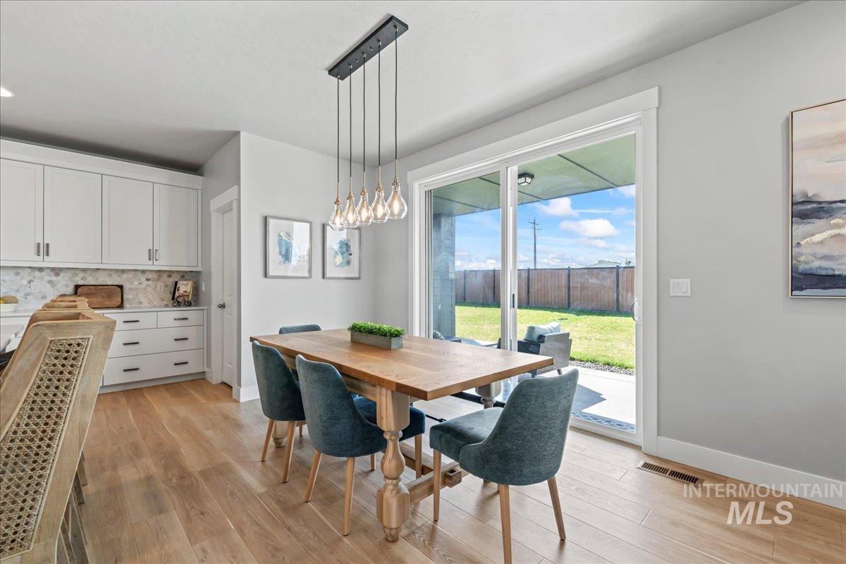 Dining area featuring light wood-style floors and baseboards