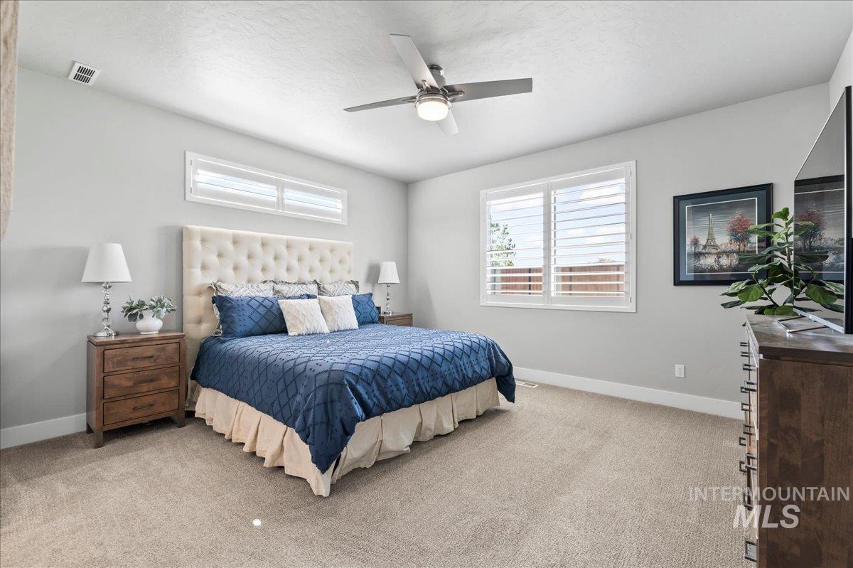 Bedroom with carpet and ceiling fan