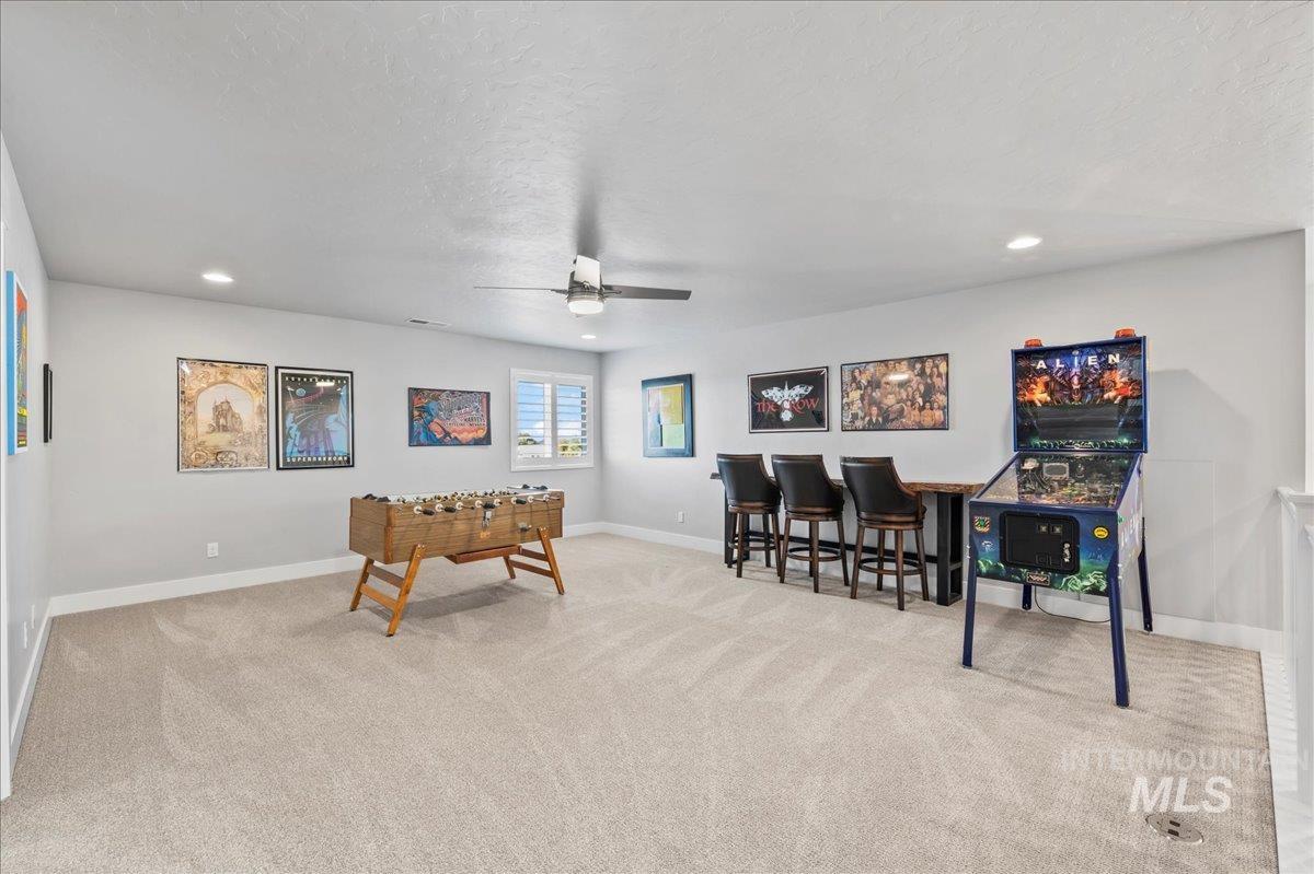 Recreation room with carpet, ceiling fan, and recessed lighting