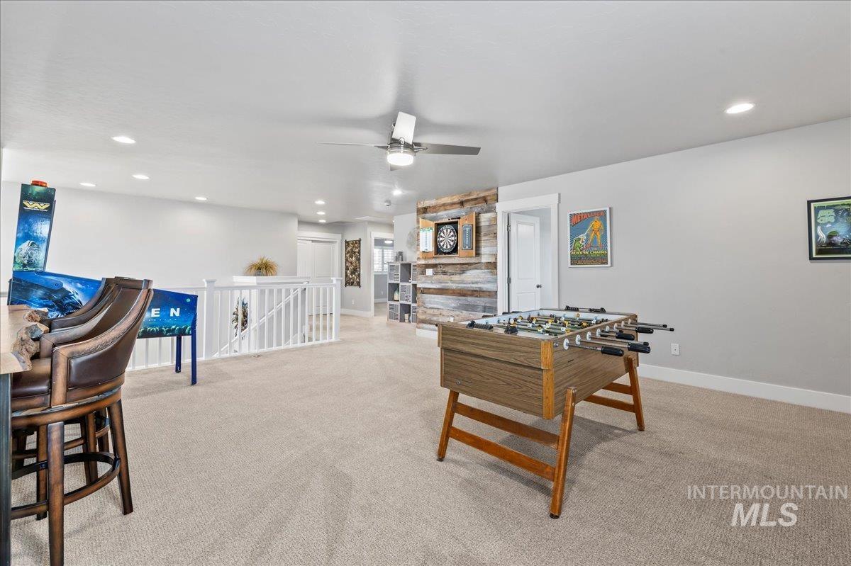 Playroom with recessed lighting, light colored carpet, and ceiling fan