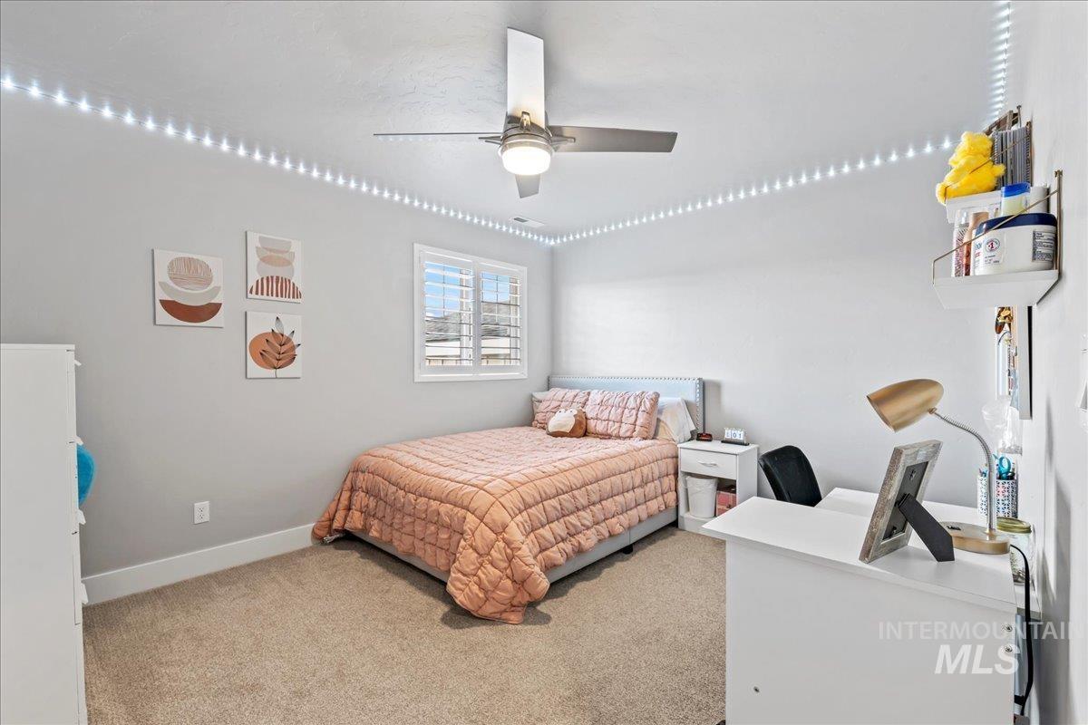 Bedroom with light carpet and ceiling fan