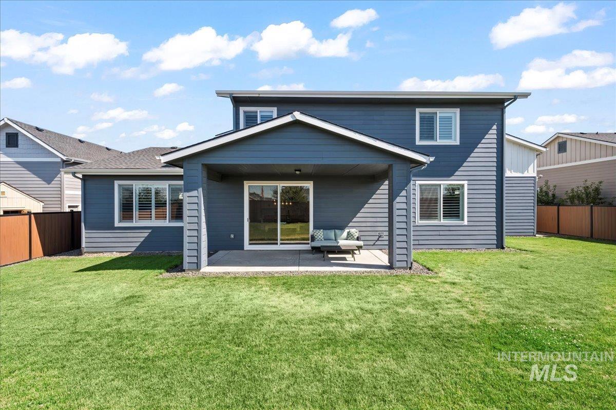 Rear view of house with a patio and a fenced backyard