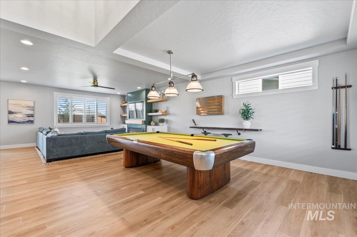Dining room with light wood-style floors, a textured ceiling, recessed lighting, a ceiling fan, and billiards table