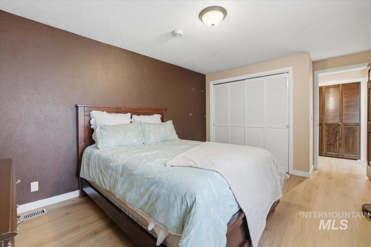 Bedroom with a closet and light wood-style flooring