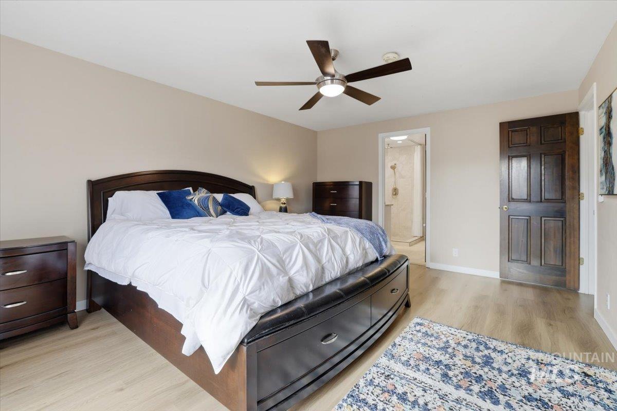 Bedroom with light wood-style floors and a ceiling fan