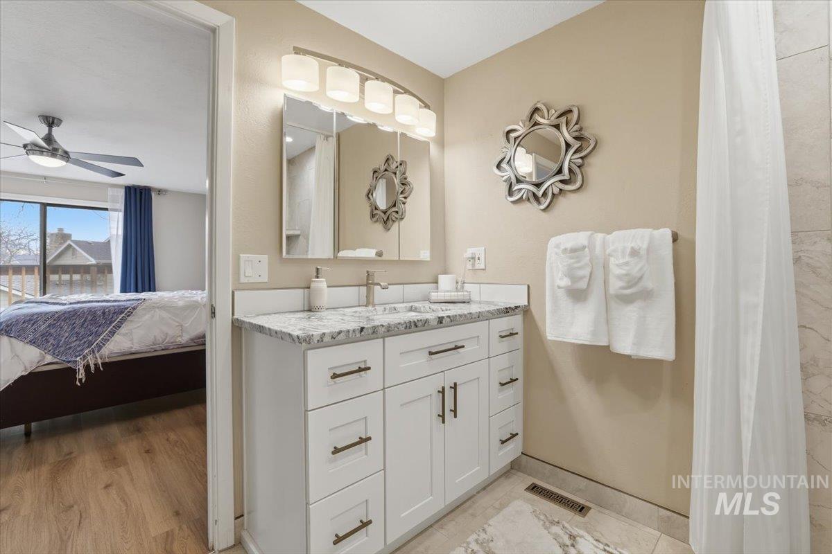 Bathroom with vanity, ensuite bathroom, and a ceiling fan