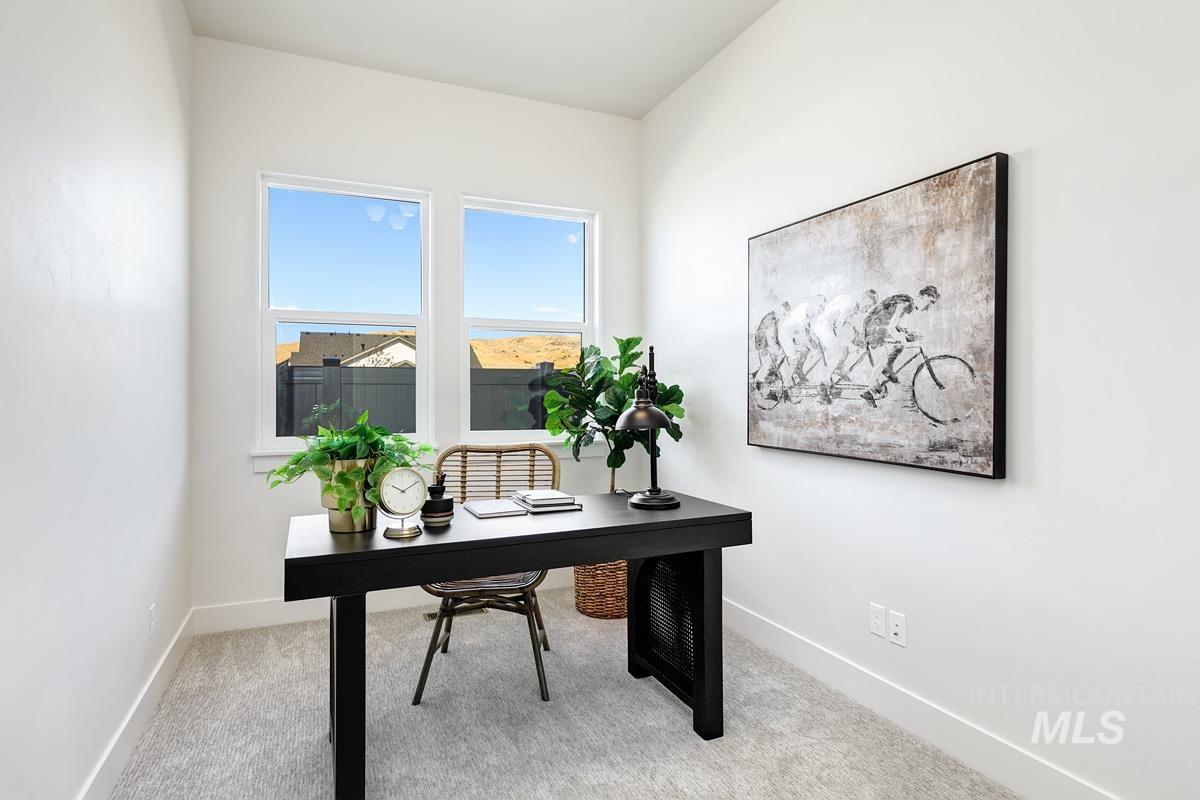 Office area featuring light carpet