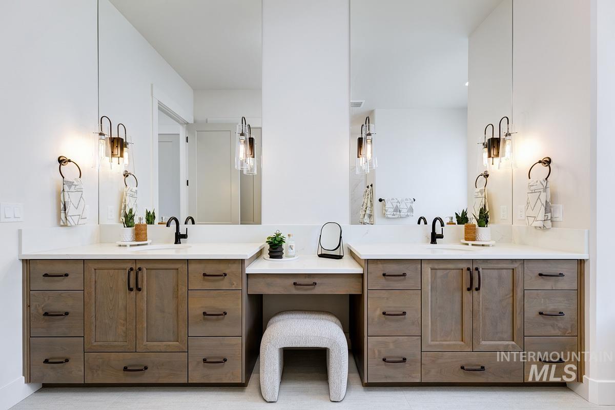 Bathroom with double vanity and baseboards