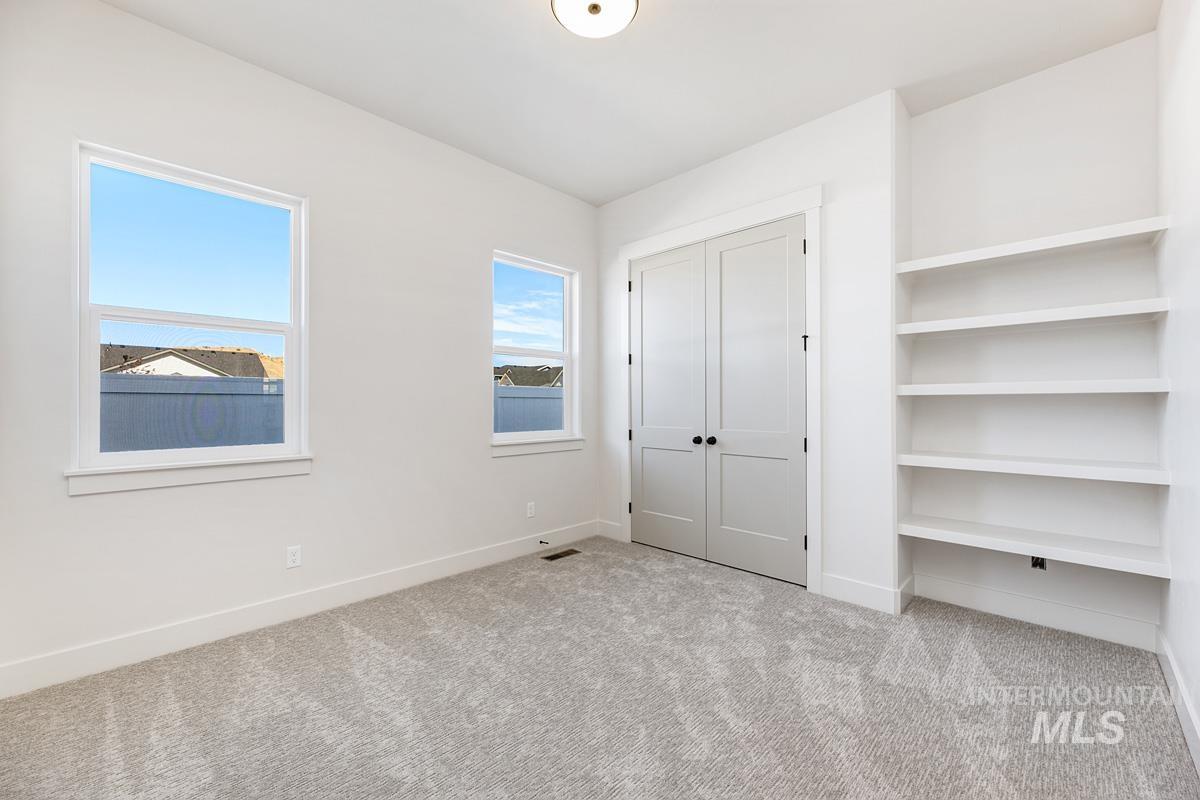 Unfurnished bedroom featuring carpet floors and a closet